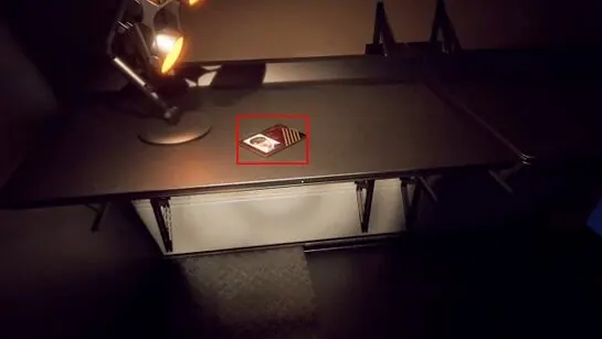 The level 5 access card outlined on a dark desk