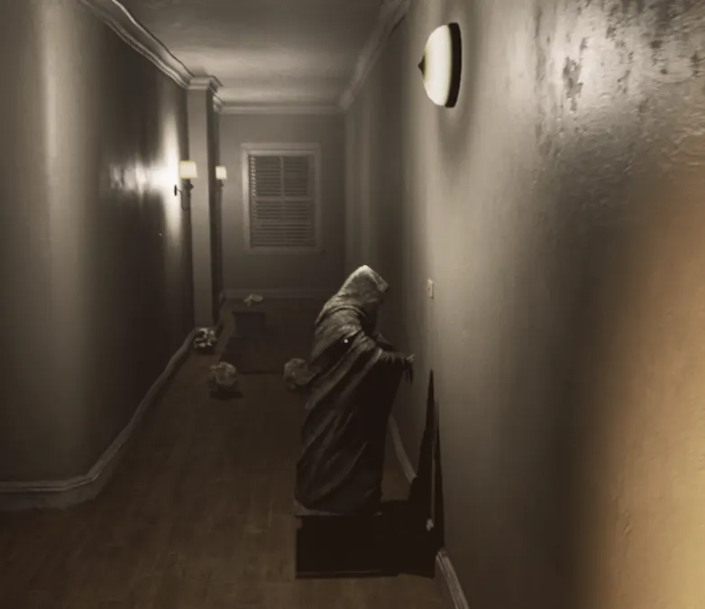 A hooded statue standing on its pedestal in one of the cabin's lit hallways